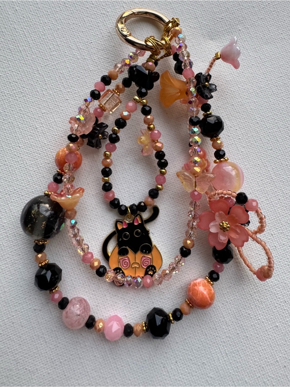 Handcrafted Pink and Black Beaded Phone Charm with Floral Accents